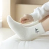 Mink fleece socks for women, thick and cold-proof, versatile home floor socks, expression embroidered fleece mid-calf socks Application Scenario